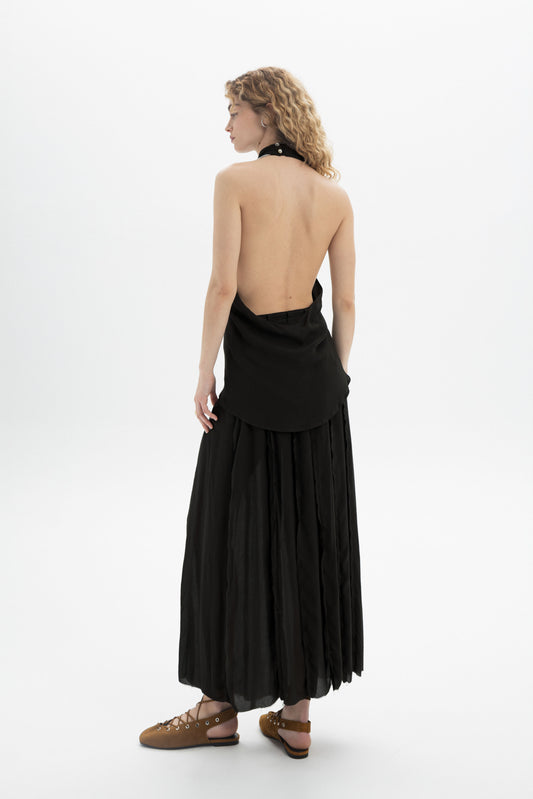 Draped Halter Top worn by a model showcasing an elegant open-back silhouette and softly draped design.