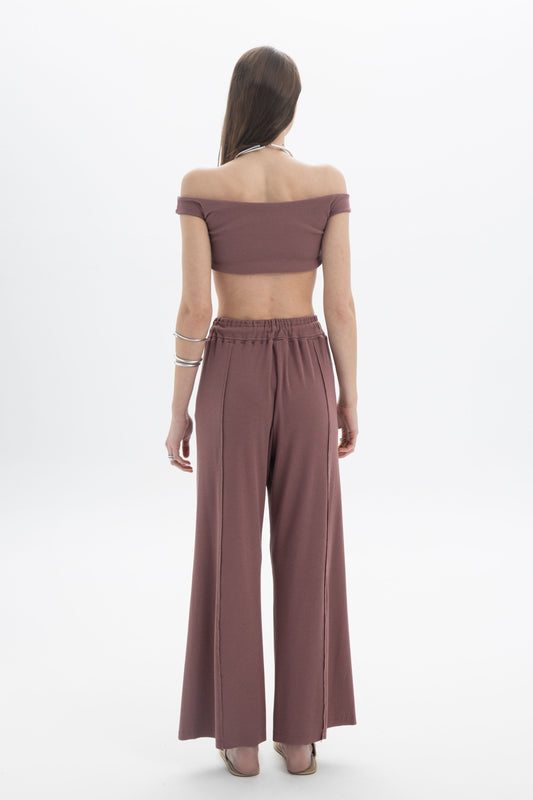 Model wearing the B&B x F Off-Shoulder Crop Top with high-waisted pants, showcasing a modern and minimal look.