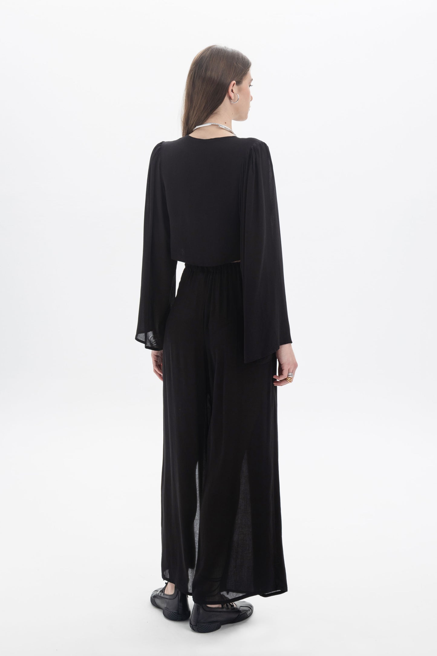 Draped Cropped Long Sleeve Top showcasing a back view with wide sleeves and a flowing silhouette.