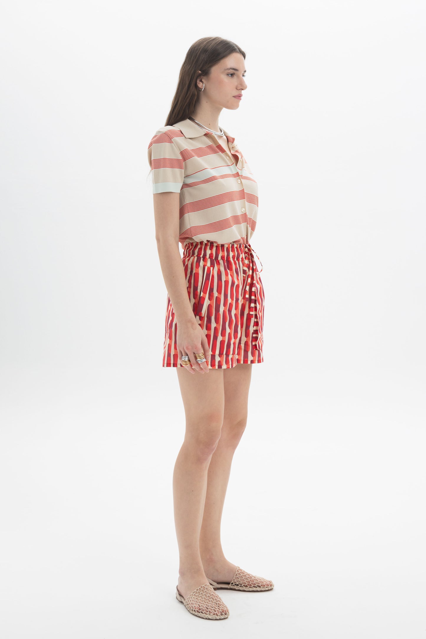 Model wearing a Striped Knit Polo with shorts, showcasing a relaxed fit and horizontal stripes for a casual look.