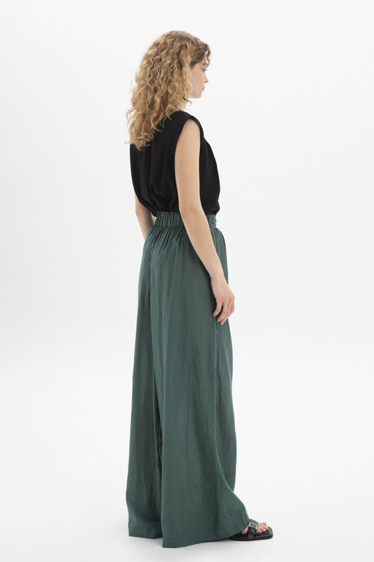 Model wearing Wide-Leg Belted Pants in green, showcasing relaxed fit and high-waisted design.