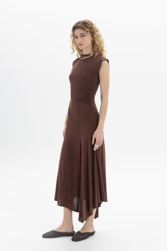 Asymmetric Midi Dress in brown with side ruching and flowing hem, elegant and feminine silhouette.