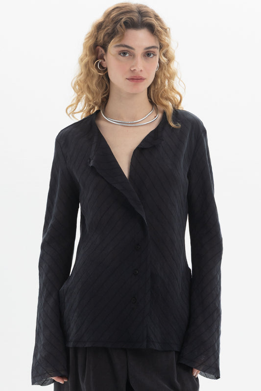 Ruffled V-Neck Blouse featuring a soft ruffled neckline and button-front detail in a relaxed fit.