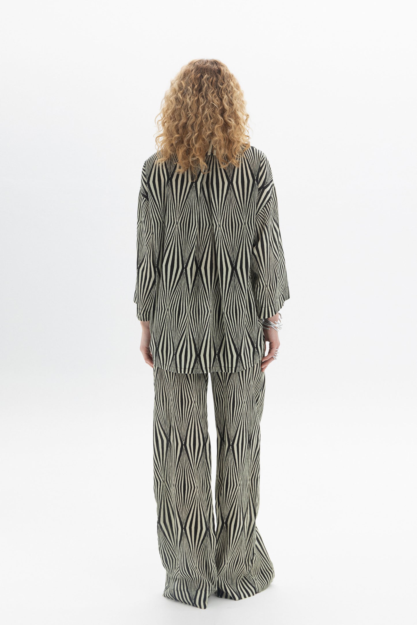 Back view of a person wearing a Relaxed Printed Shirt with a graphic pattern and relaxed-fit style.