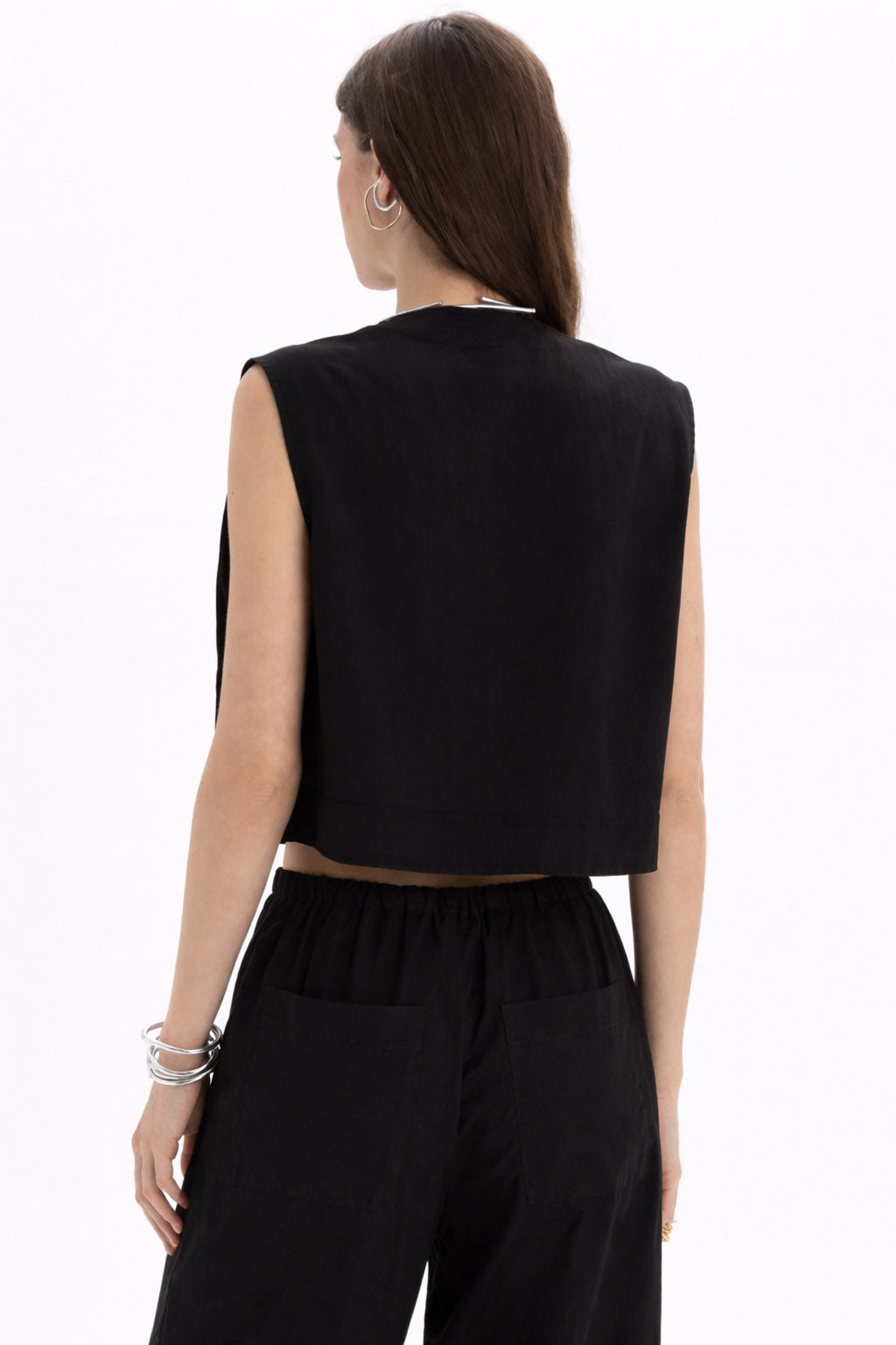Back view of Pleated Cropped Sleeveless Top in black, showcasing modern cropped design and minimalist style.