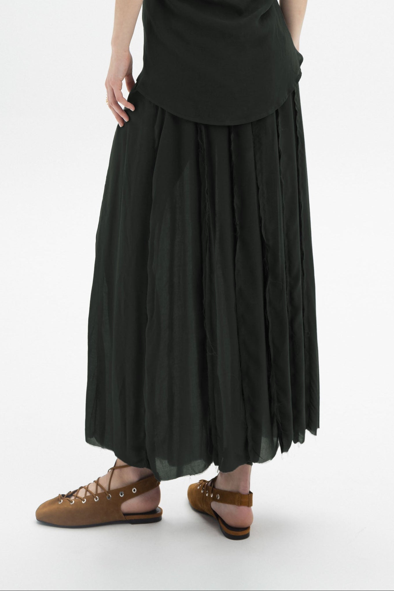 Sheer Layered Maxi Skirt showcases a relaxed silhouette with layered construction and a flowy sheer outer layer.