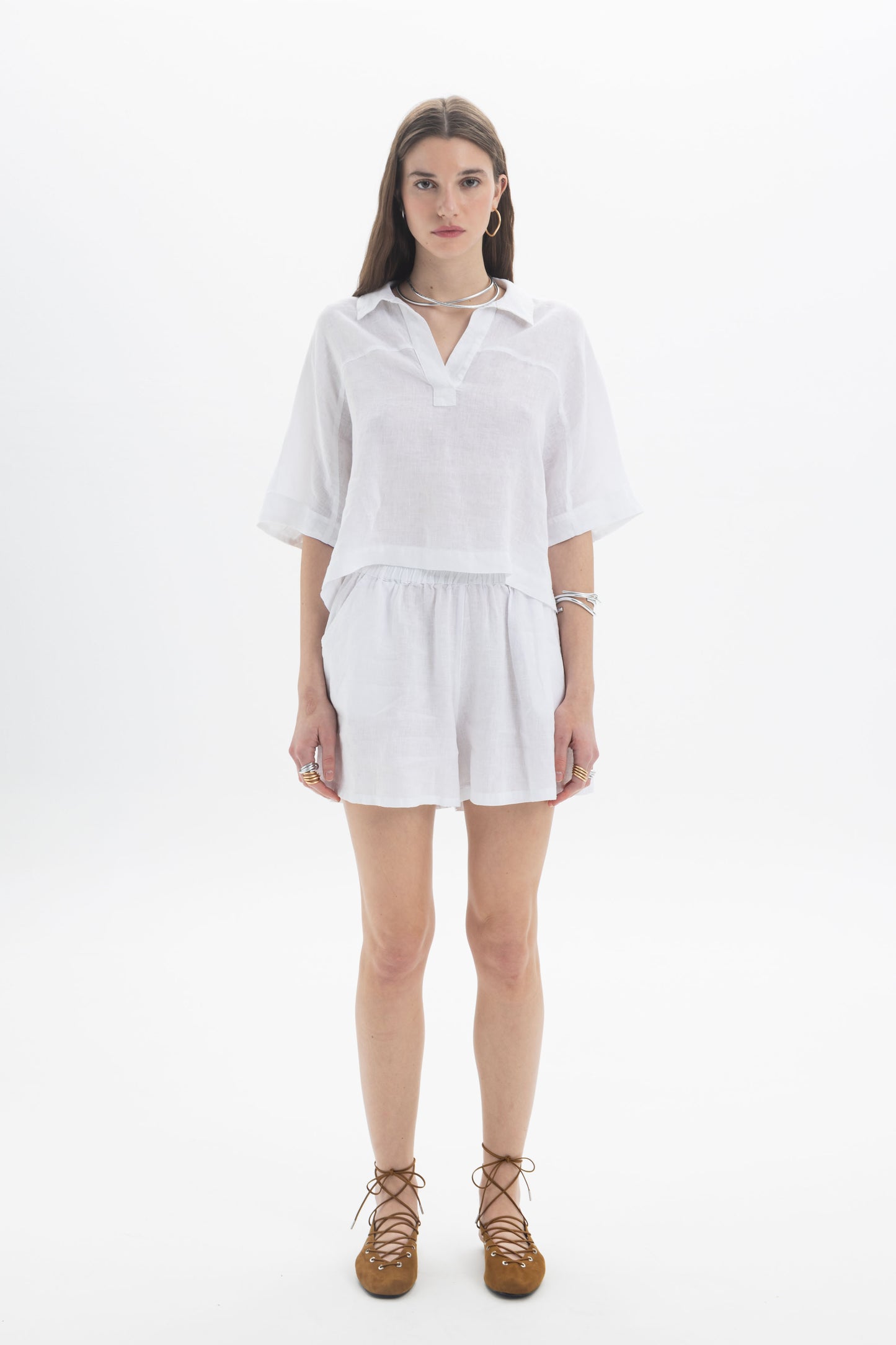 Model wearing a Linen Polo Top, a lightweight cropped linen top with a soft collar and relaxed fit.