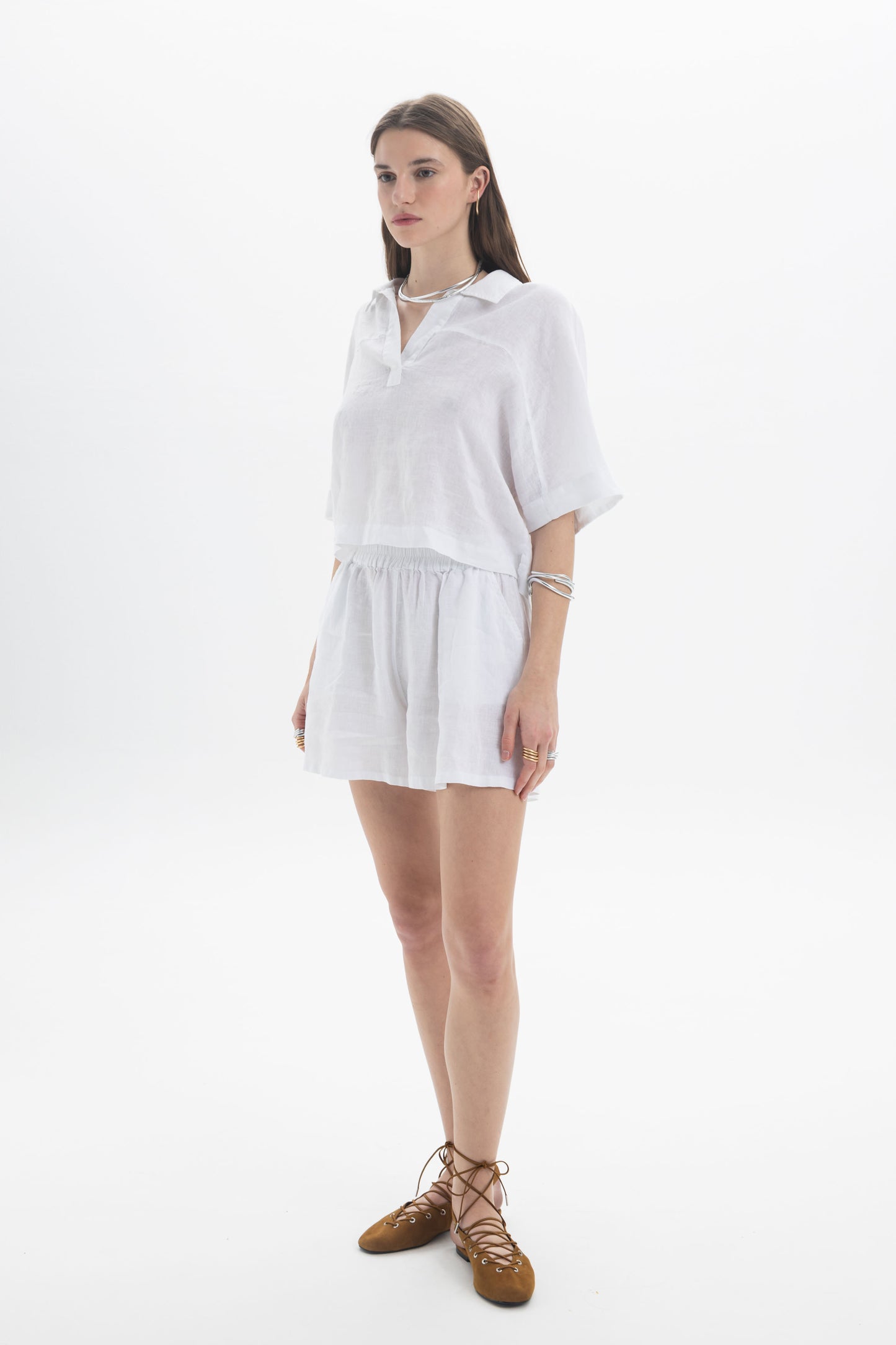 Model wearing a Linen Polo Top, showcasing breathable linen fabric and relaxed fit with short sleeves.