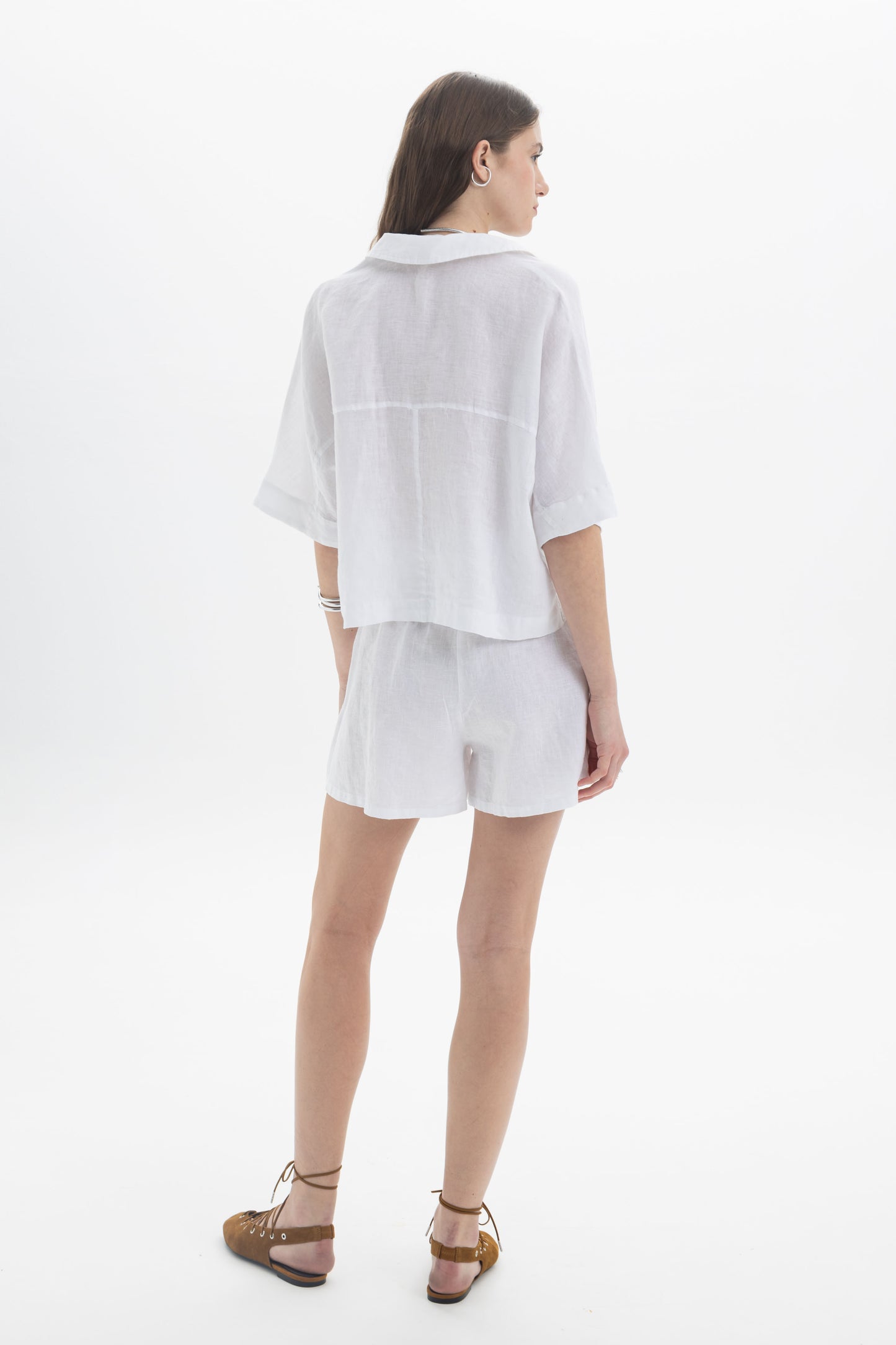 Linen Polo Top displayed on a model, showcasing its relaxed fit and soft polo-style collar.