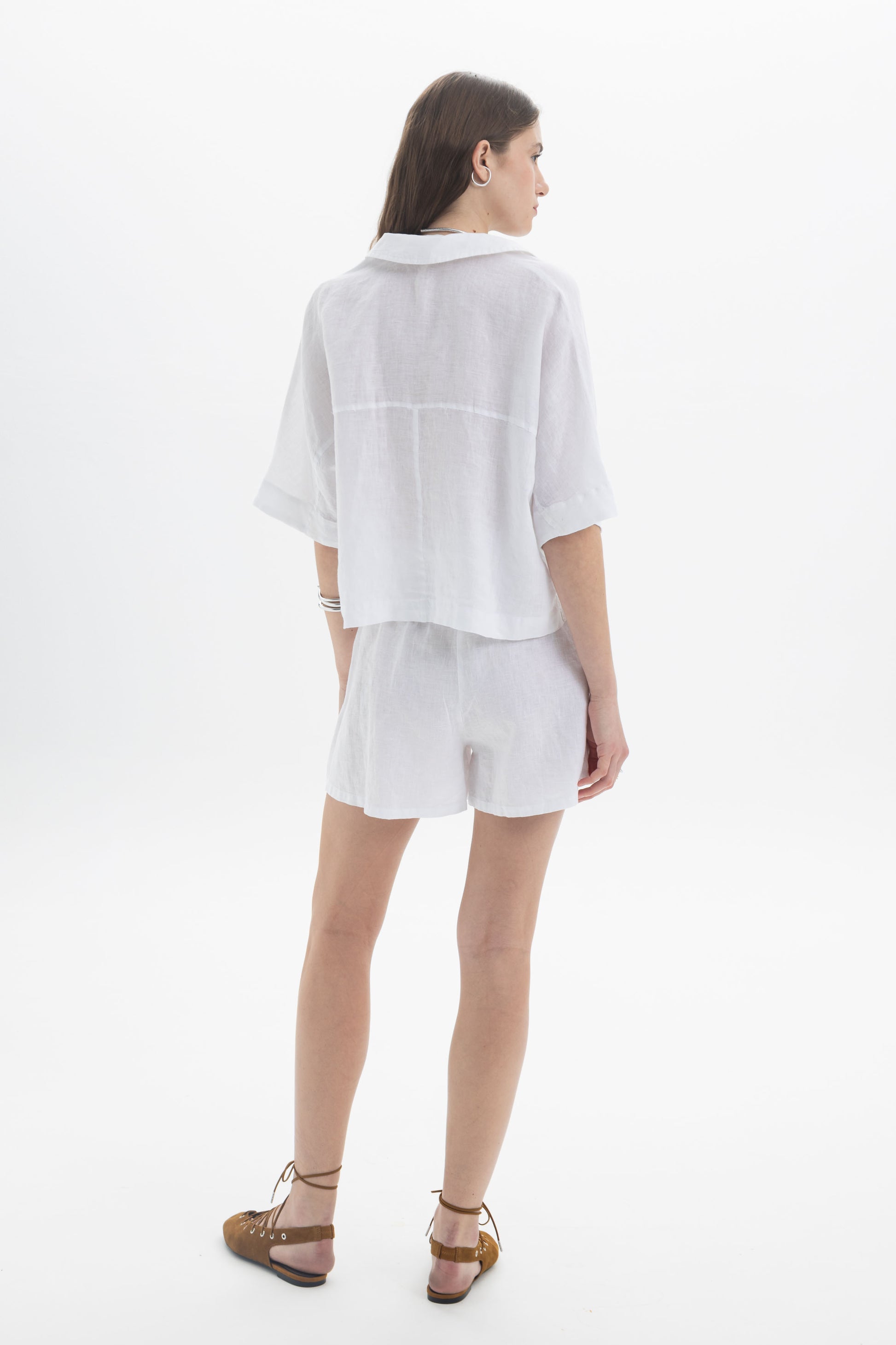 Linen Polo Top displayed on a model, showcasing its relaxed fit and soft polo-style collar.