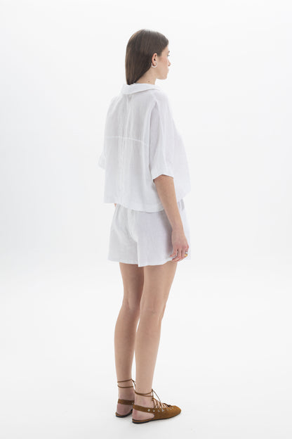 Linen Polo Top featuring a lightweight cropped design with a relaxed silhouette and soft polo-style collar.