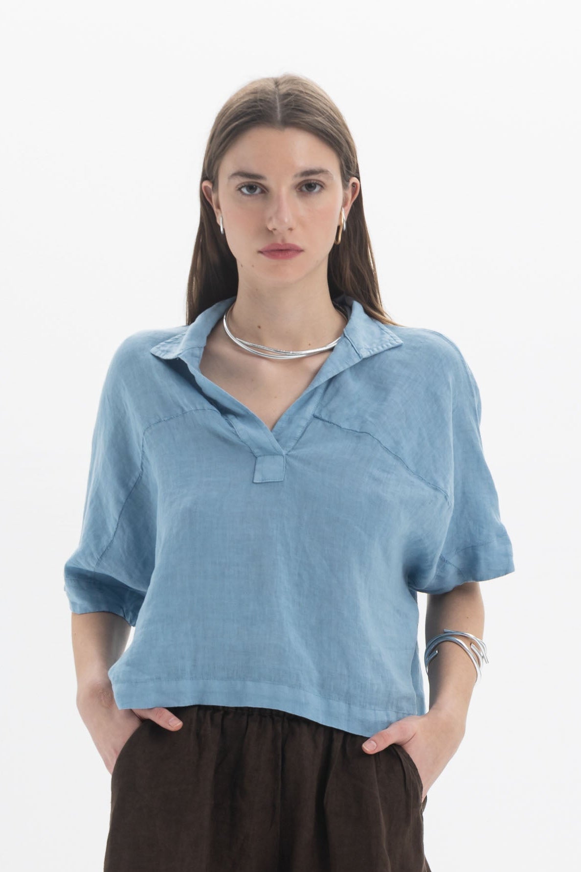 Linen Polo Top in light blue, featuring a soft polo collar, short sleeves, and a relaxed fit.