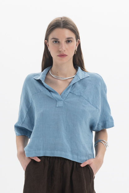 Linen Polo Top in light blue, featuring a soft polo collar, short sleeves, and a relaxed fit.