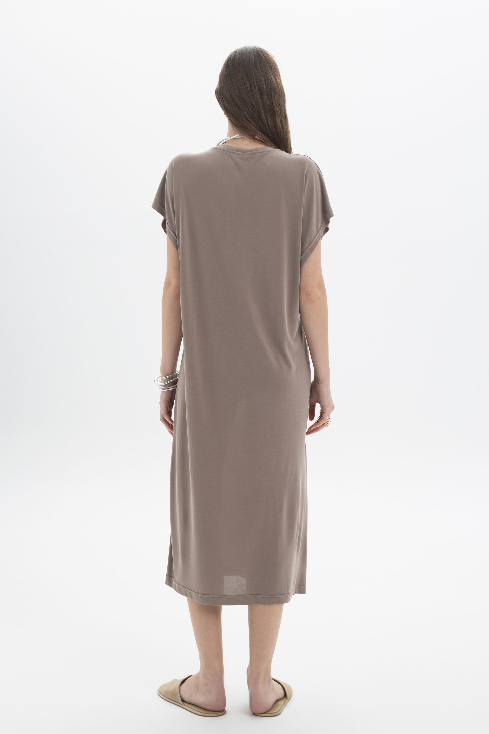 Woman wearing a Relaxed Midi Dress in a soft, fluid fabric with a relaxed silhouette and dropped shoulders.