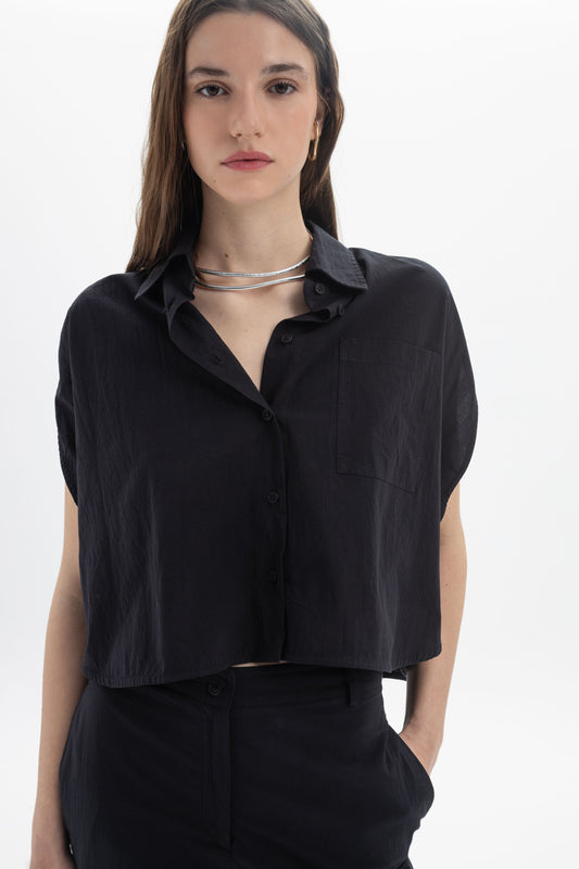 Cropped Button Shirt featuring a relaxed fit, classic collar, short cap sleeves, and a chest pocket for summer styling.