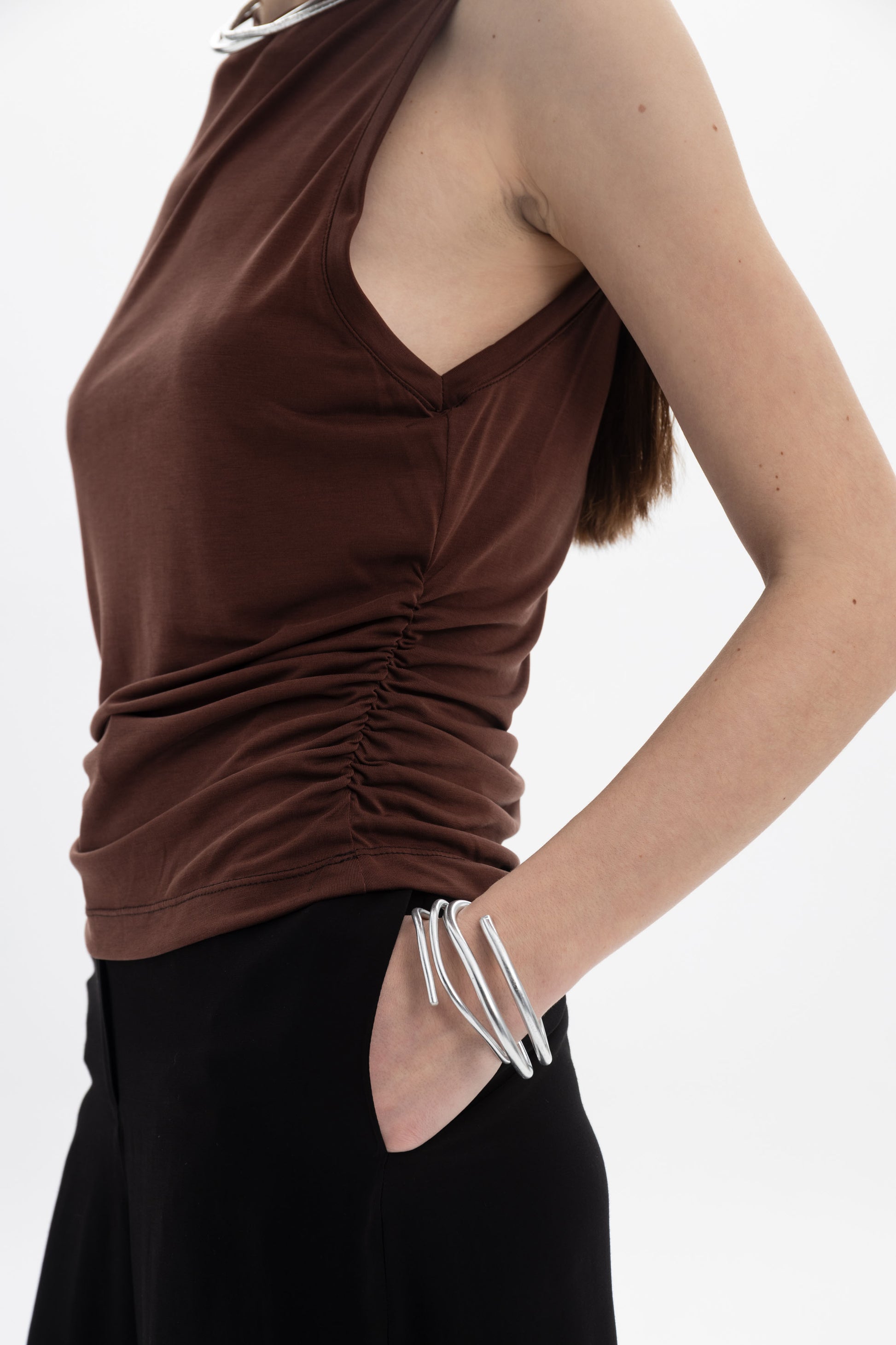 Ruched Sleeveless Top in brown with side ruching, high neckline, styled with silver jewelry.