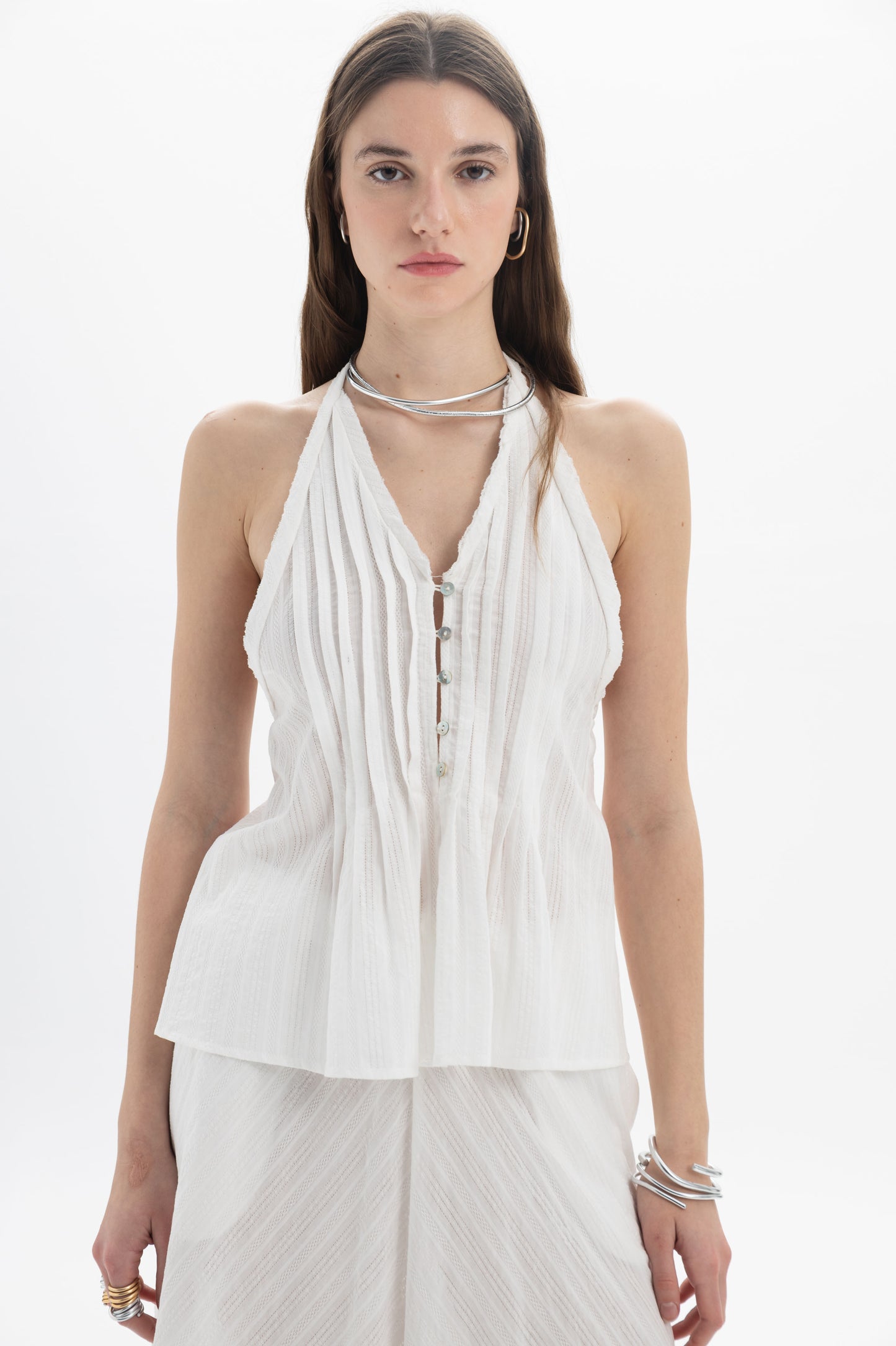 Lightweight Pleated Halter Peplum Top with vertical pleats and tied back, perfect for skirts or tailored trousers.