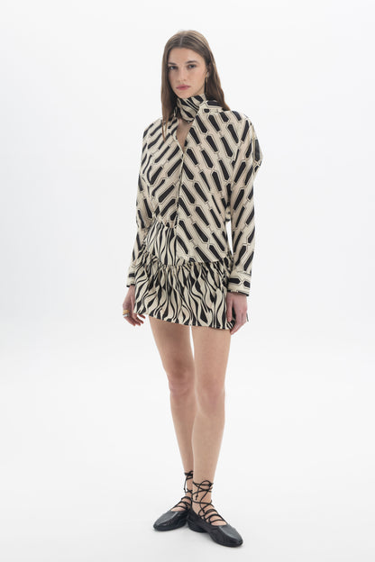 Model wearing Ruffle Hem Skort featuring a gathered ruffle hem and zebra-inspired print in a playful style.