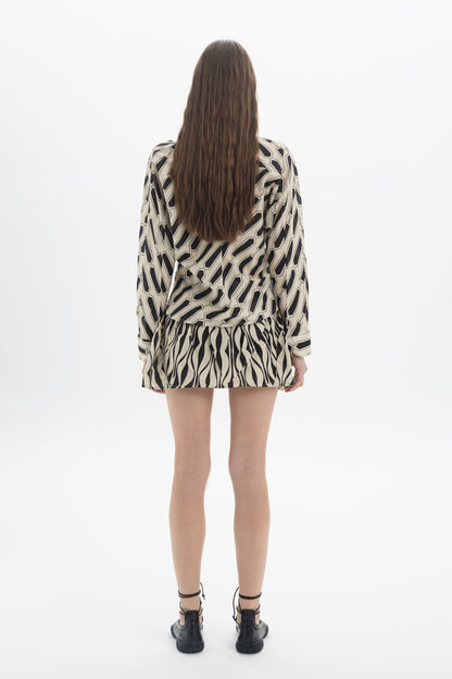 Back view of a model wearing a Graphic Print Collar Shirt with bold geometric print and relaxed fit.