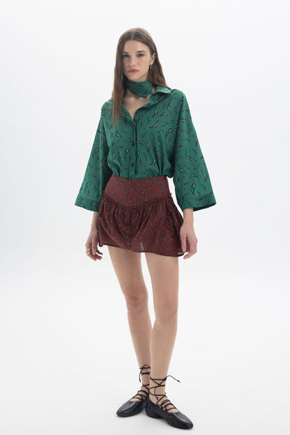 Three-Quarter Sleeves Shirt in green print with three-quarter sleeves, paired with a patterned skirt.