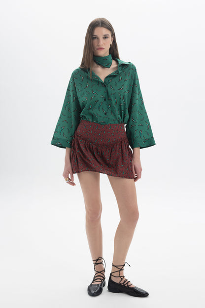 Three-Quarter Sleeves Shirt in green print, styled with a red skirt and black flats, perfect for casual outings.