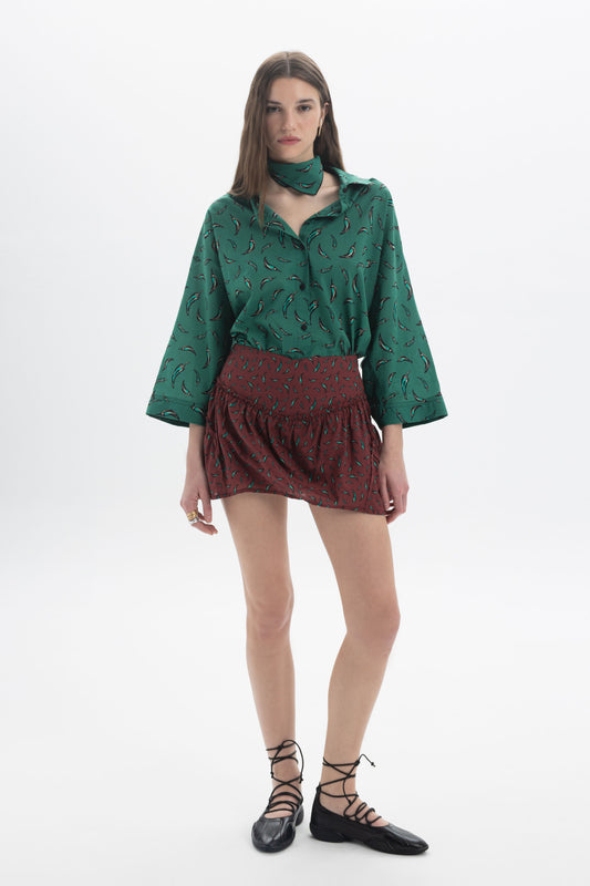 Three-Quarter Sleeves Shirt in green print, styled with a red skirt and black flats, perfect for casual outings.