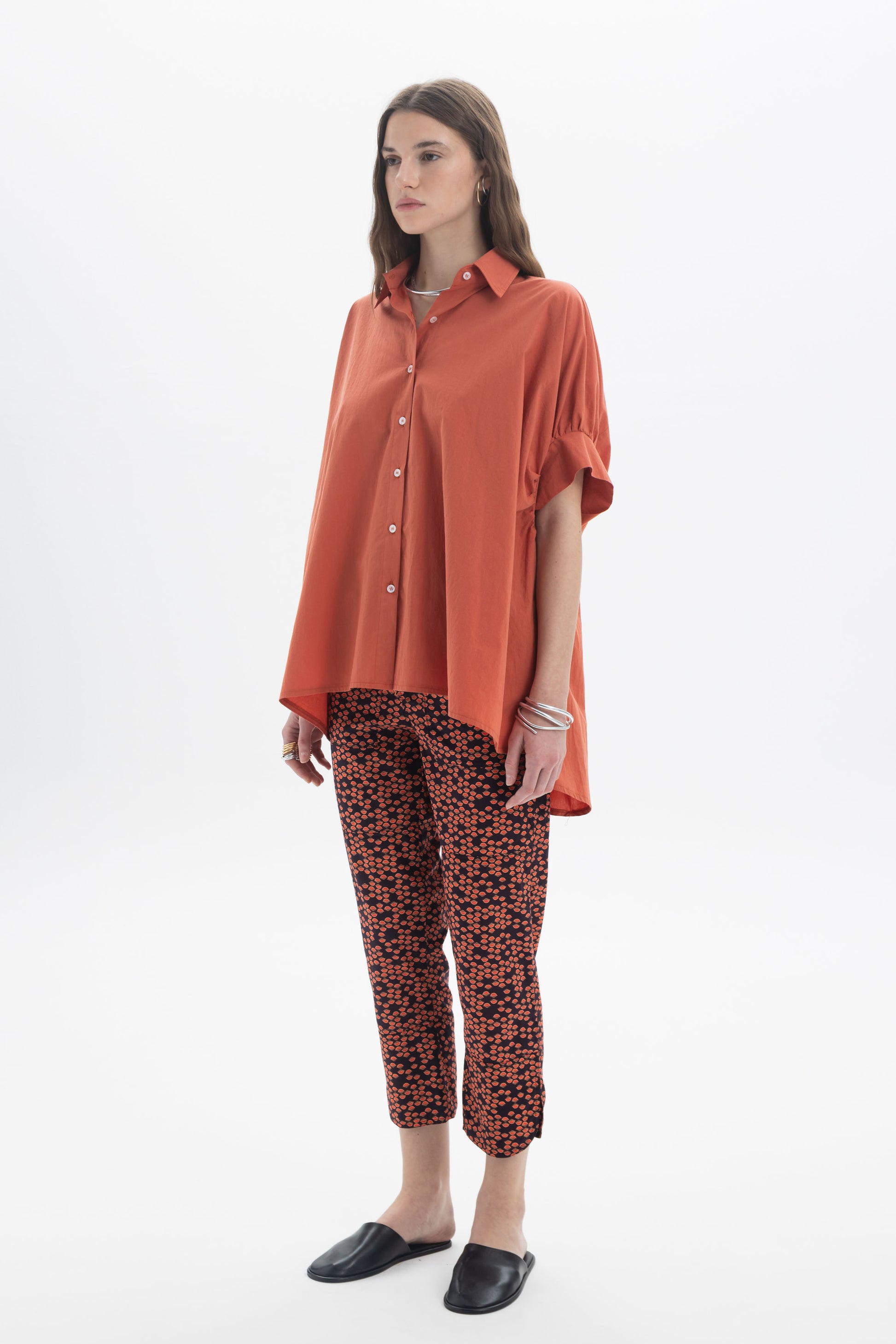 Model wearing Cropped Printed Pants with an oversized orange shirt, showcasing everyday styling.