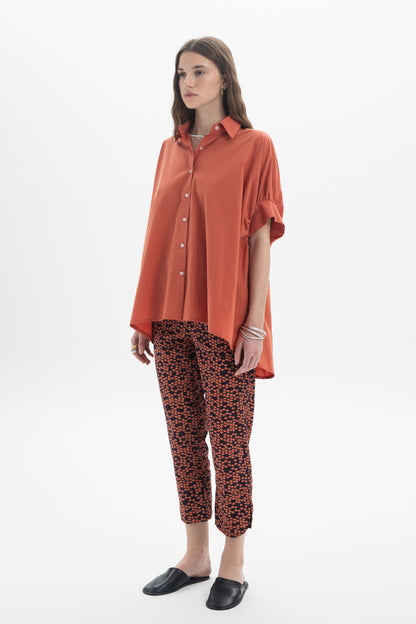 Model wearing Cropped Printed Pants with an oversized orange shirt, showcasing everyday styling.
