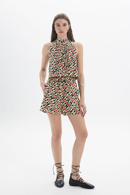 Model wearing a Pleated Halter Top with graphic print and pleating, styled with a modern fit.