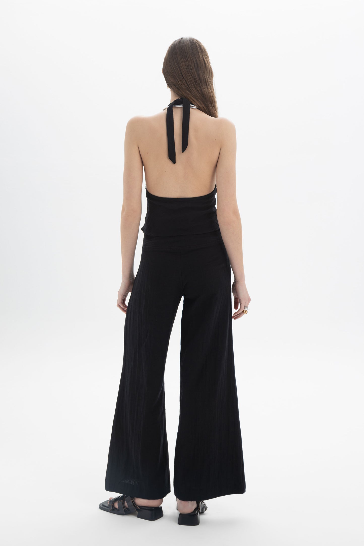 Halter Neck Fitted Top showcasing a deep V neckline and open back tied at the neck, highlighting the fitted silhouette.