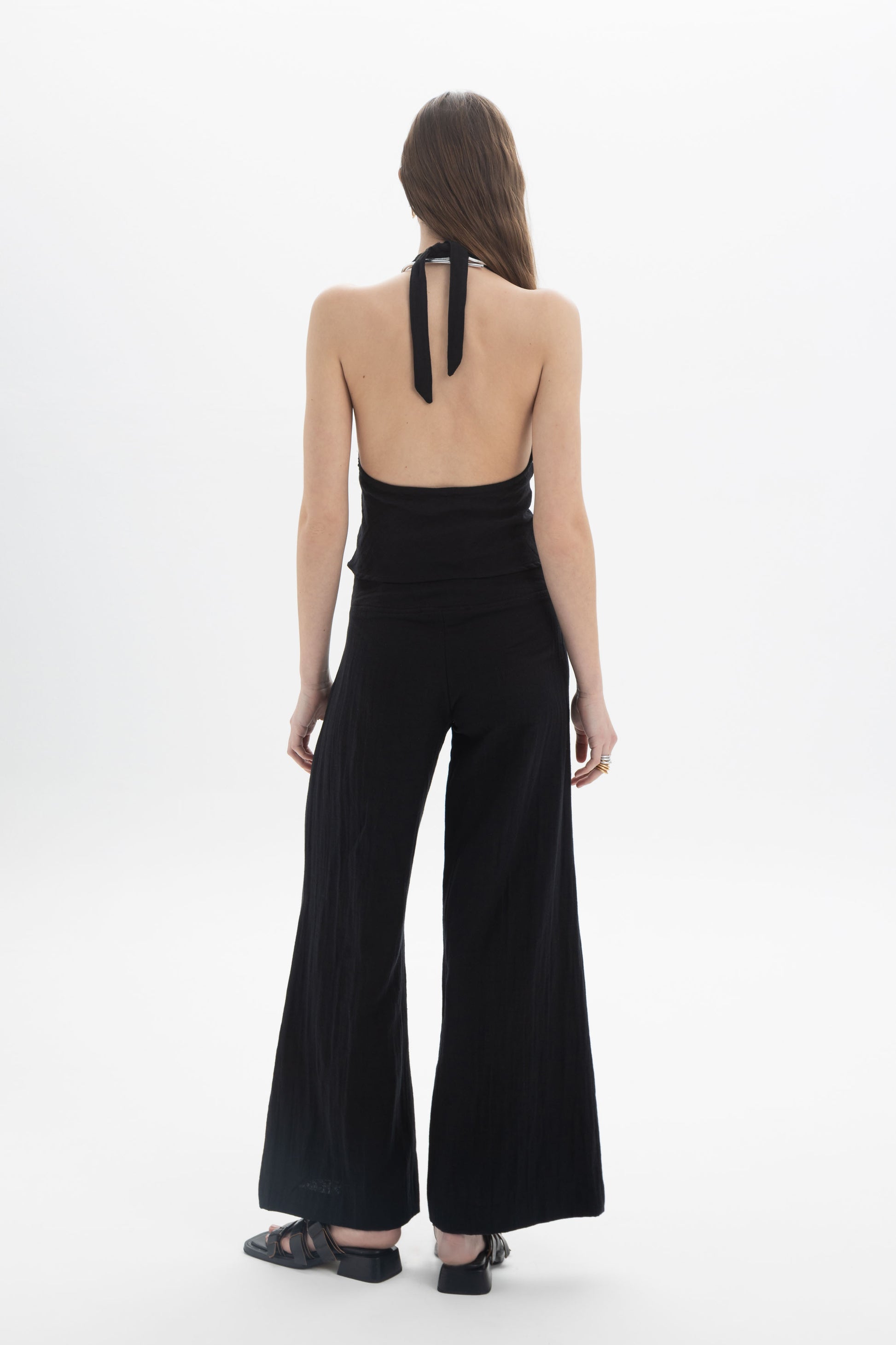 Halter Neck Fitted Top showcasing a deep V neckline and open back tied at the neck, highlighting the fitted silhouette.