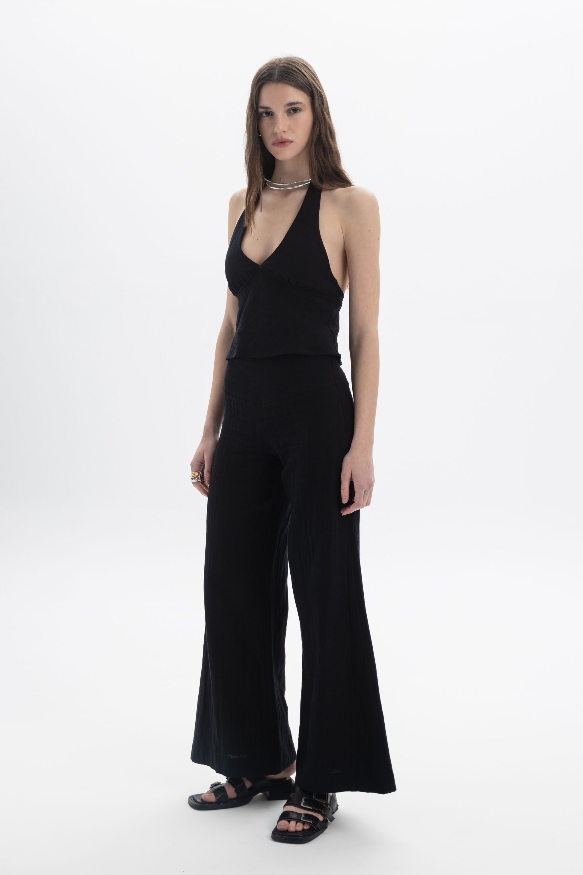 Halter Neck Fitted Top on model showcasing a deep V neckline and open back design.