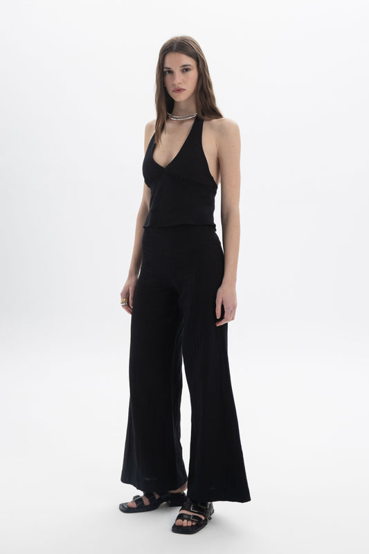 Halter Neck Fitted Top on model showcasing a deep V neckline and open back design.
