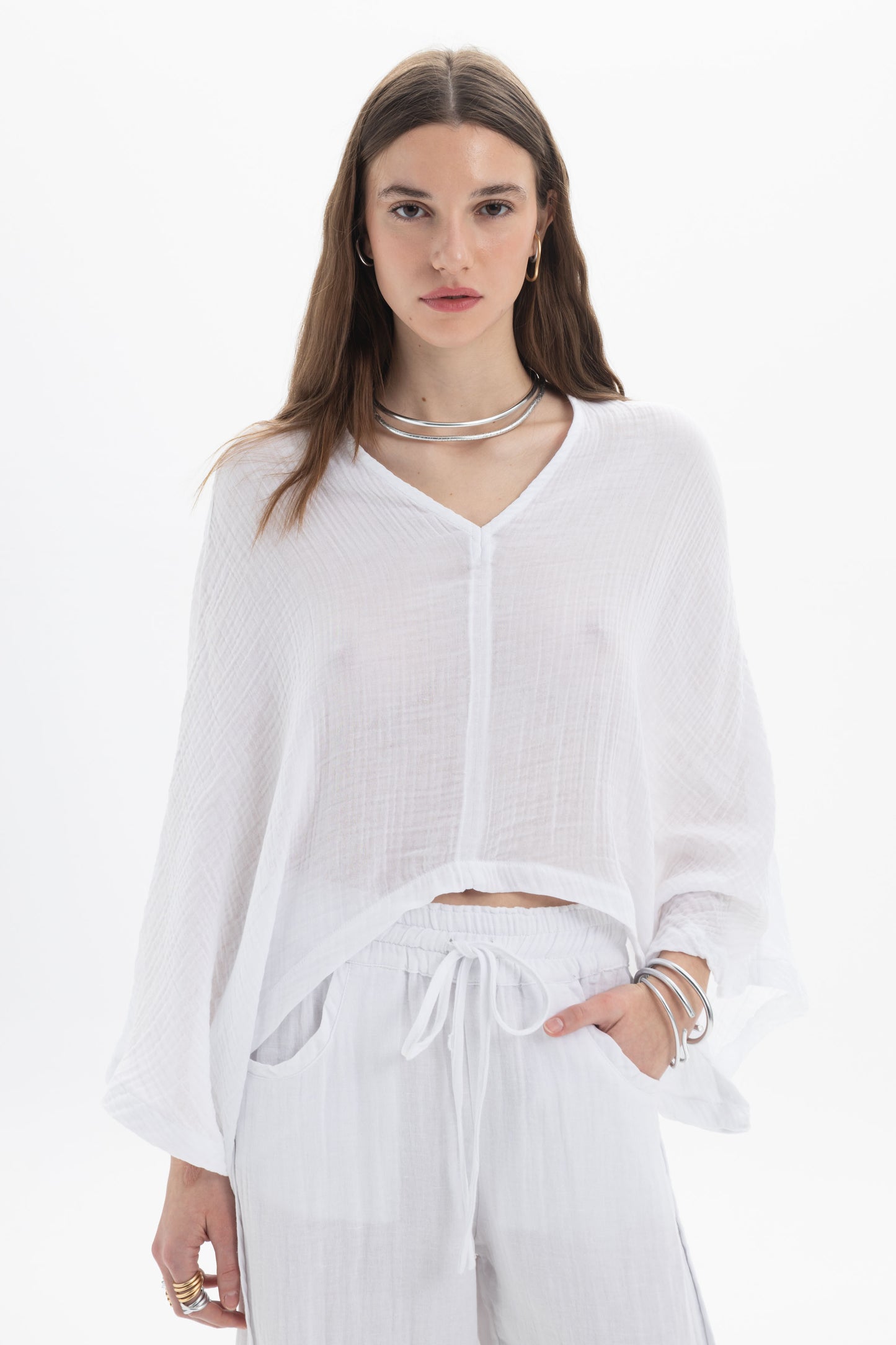 Sheer V-Neck Blouse featuring a lightweight fabric, relaxed silhouette, and wide flowing sleeves in white.