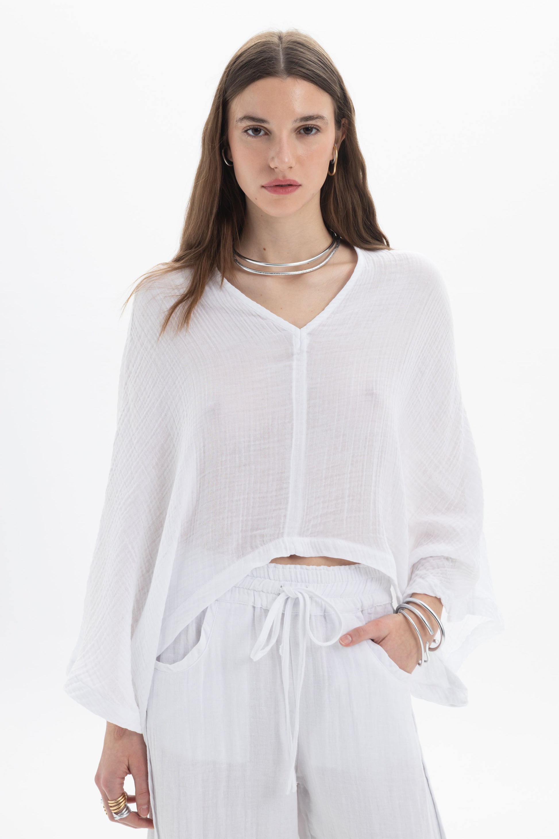 Sheer V-Neck Blouse featuring a lightweight fabric, relaxed silhouette, and wide flowing sleeves in white.