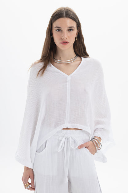 Sheer V-Neck Blouse featuring a lightweight fabric, relaxed silhouette, and wide flowing sleeves in white.