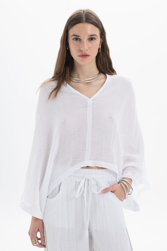 Sheer V-Neck Blouse featuring a lightweight fabric, relaxed silhouette, and wide flowing sleeves in white.