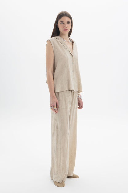 Sleeveless Textured Collar Blouse on a model, featuring a soft collar, front button closure, and relaxed linen blend fabric.
