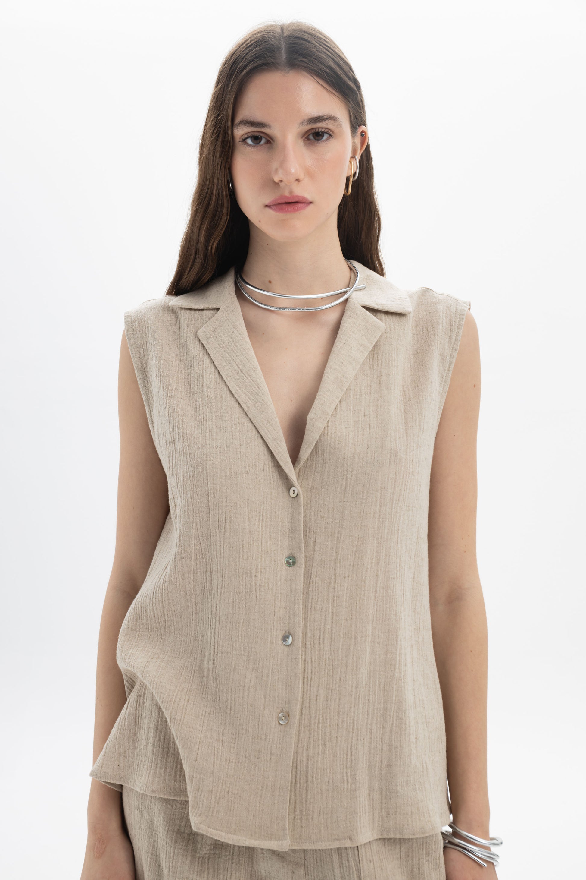 Sleeveless Textured Collar Blouse on model with soft collar and front button closure, made of linen and cotton blend.
