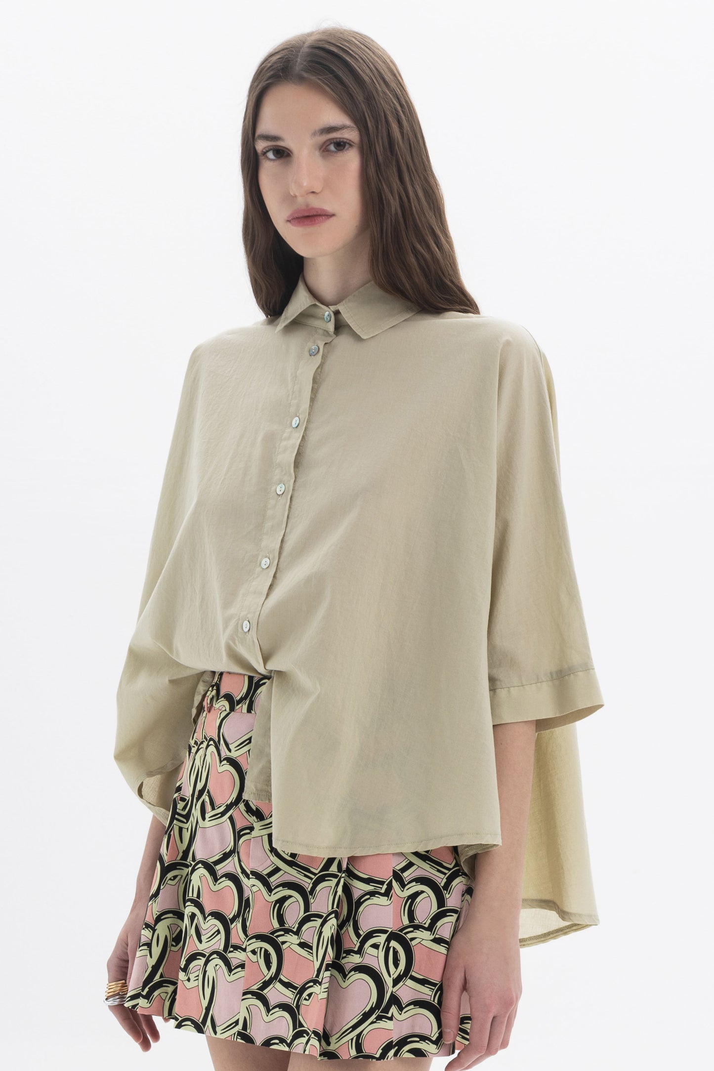 Elbow Length Shirt in beige with classic collar and oversized fit, paired with a patterned skirt.