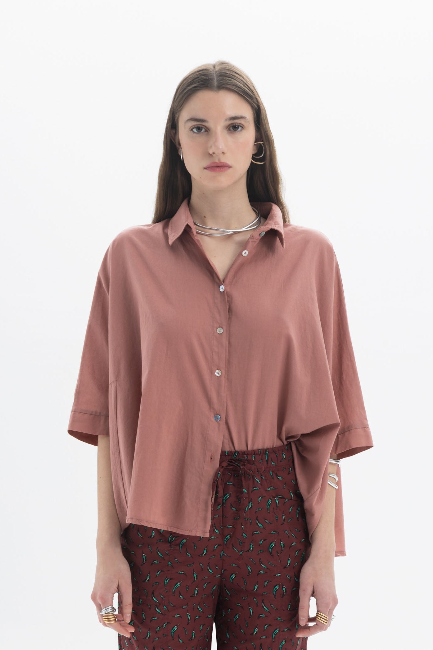 Oversized Short Sleeve Shirt in rust color with classic collar and front button closure, styled with wide short sleeves.