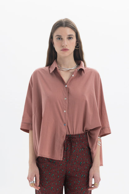 Oversized Short Sleeve Shirt in rust color with classic collar and front button closure, styled with wide short sleeves.
