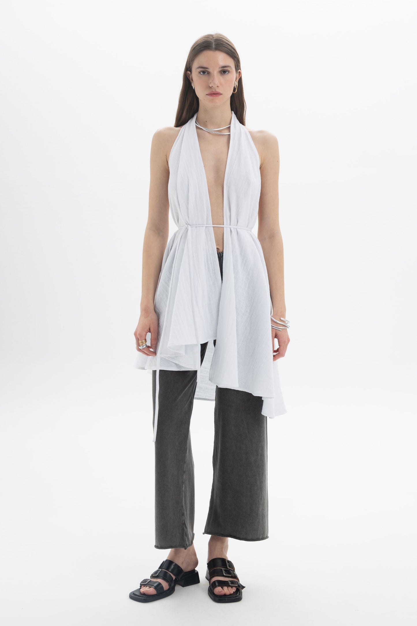 Model wearing a Longline Halter Top with draped panels and adjustable waist tie over trendy wide-leg pants.