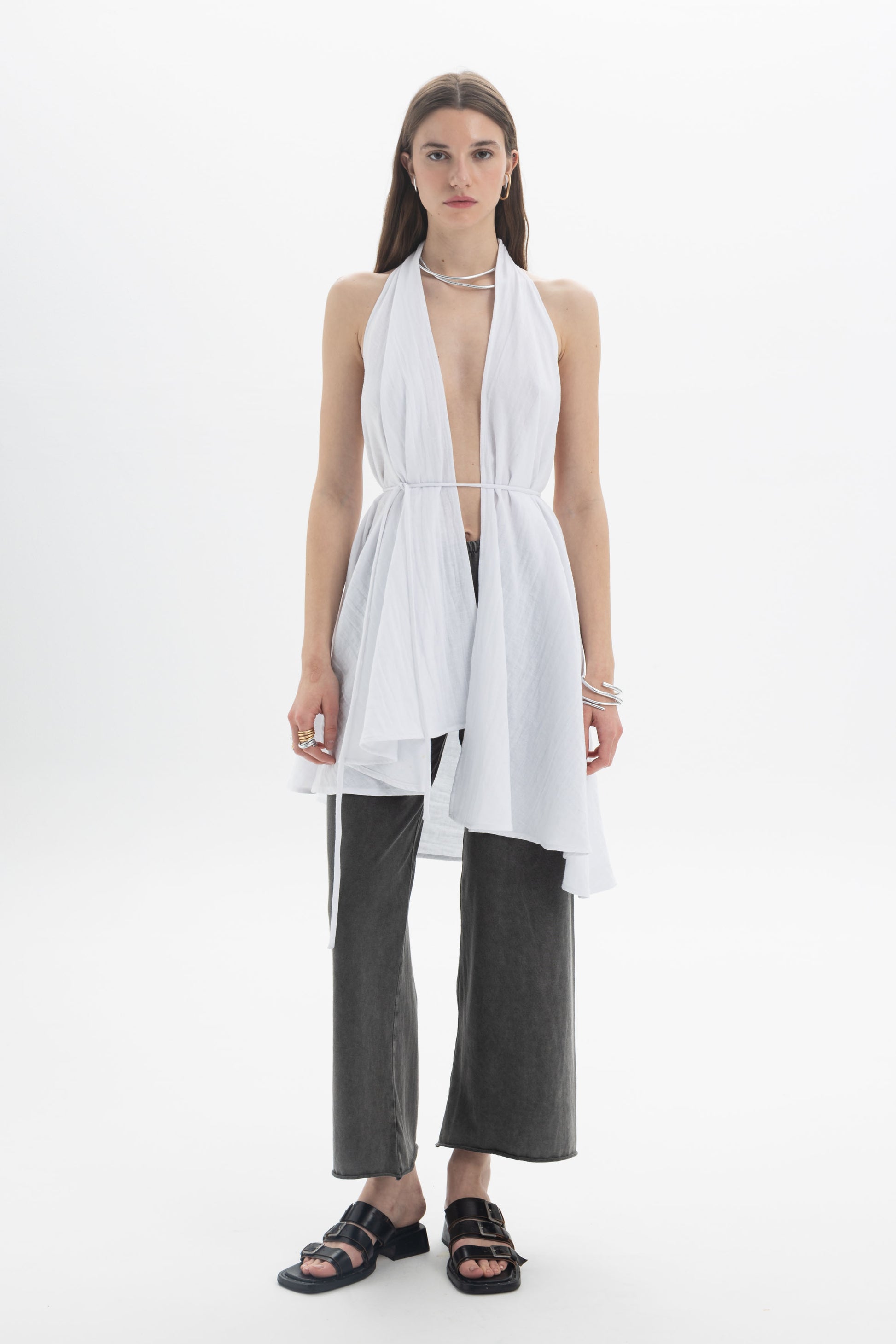 Model wearing a Longline Halter Top with draped panels and adjustable waist tie over trendy wide-leg pants.