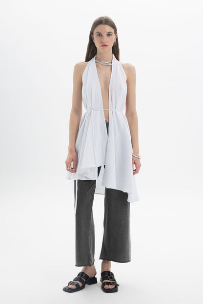 Model wearing a Longline Halter Top with draped panels and adjustable waist tie over trendy wide-leg pants.