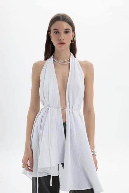 Model wearing a Longline Halter Top with an open neckline and adjustable waist tie, styled for versatile layering.