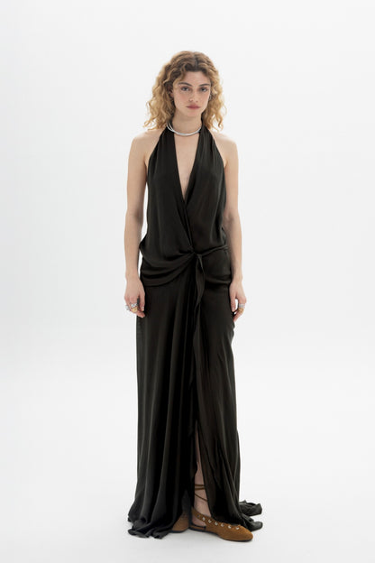 Black halter wrap maxi dress with deep neckline and open back, featuring wrap-style front and front slit.