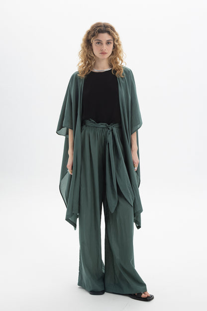 Model wearing a Sheer Kimono over a black top and matching green pants, showcasing its relaxed and airy design.