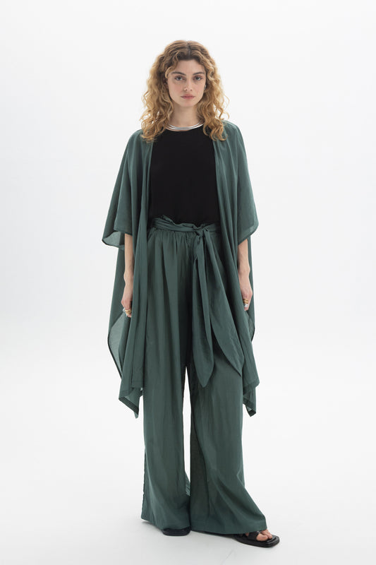 Model wearing a Sheer Kimono over a black top and matching green pants, showcasing its relaxed and airy design.
