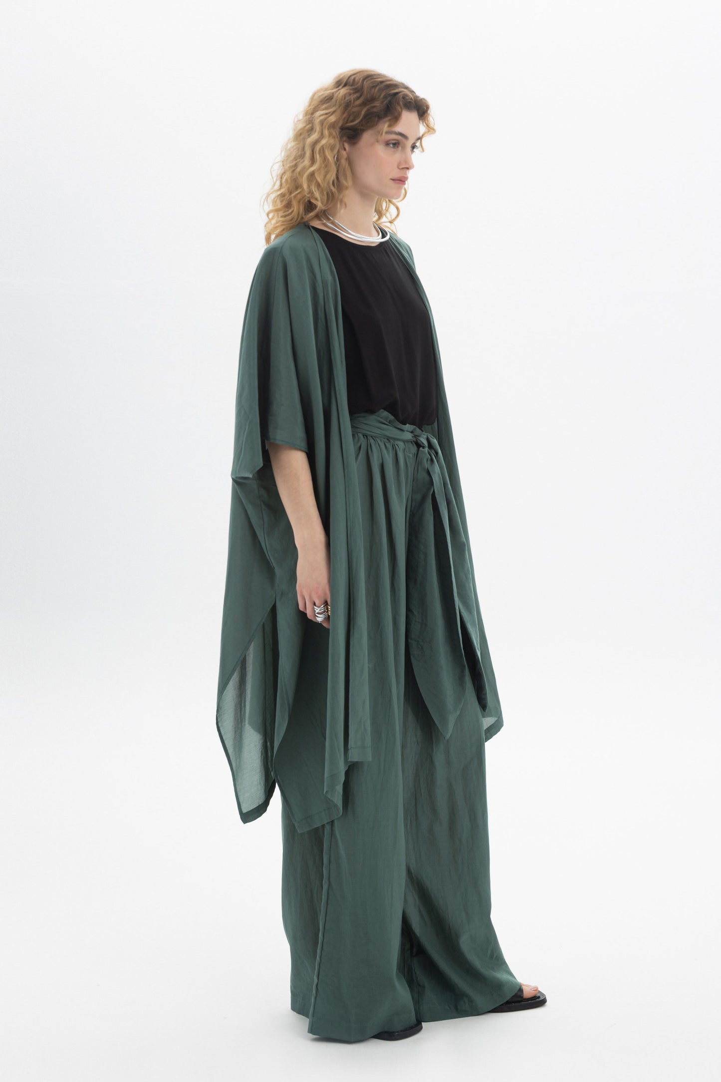 Model wearing a lightweight Sheer Kimono with wide sleeves, styled over a black top and loose pants.